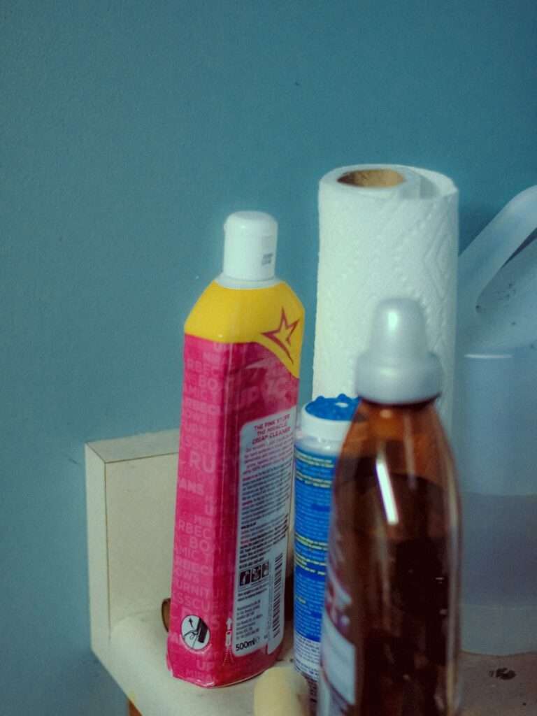 A bathroom counter with toiletries and hand sanitizers on it